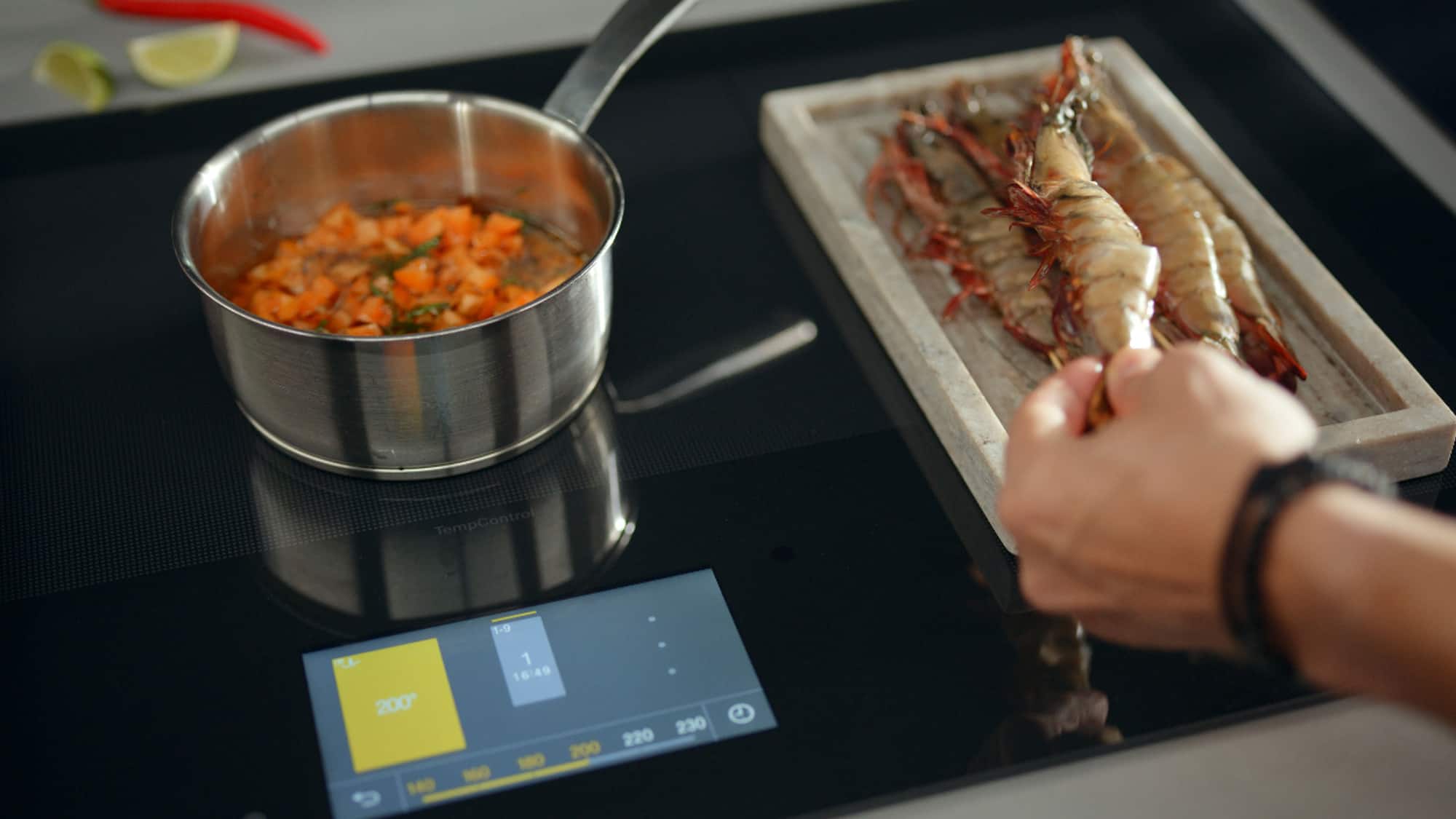 A person using her mobile phone to control the Miele coffee machine